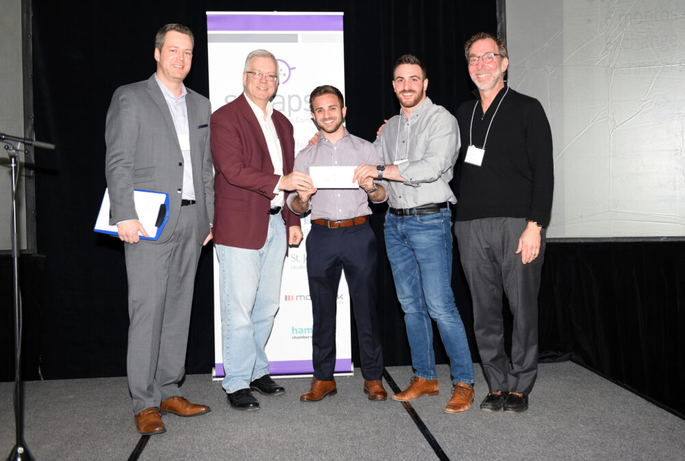 Winners of the 2018 Life Science Pitch Competition, CoHealth, being presented a cheque